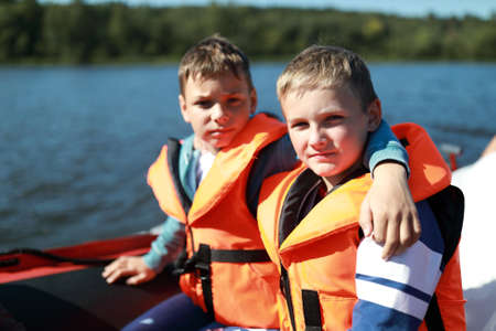 Two children in life jacket on boat in Ladoga skerriesの写真素材