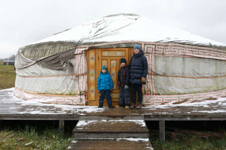 Family in front of Yakut yurt in spring, Russiaの写真素材