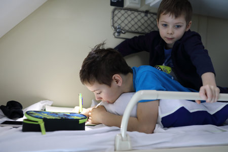 Portrait of brothers on top shelf of train compartment