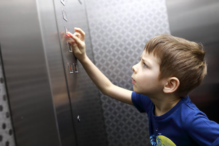 Kid is calling elevatorの写真素材