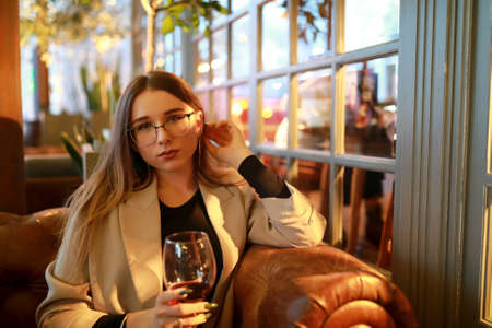 Woman with glass of red wine in restaurant