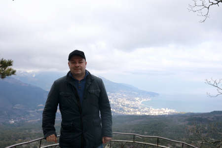 Man posing on observation deck of silver gazebo, Pendikul Mountain, Crimeaの写真素材