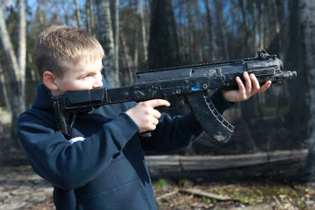 Boy playing laser tag in the park