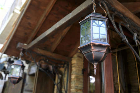 View of iron lantern on veranda of buildingの写真素材