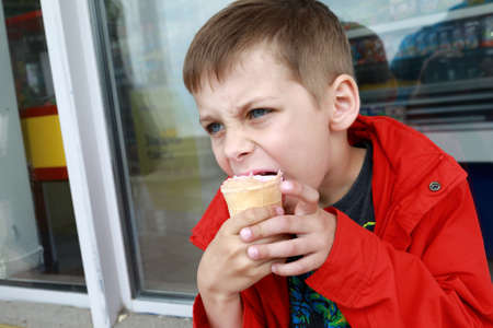 Portrait of child eating ice cream outdoorの写真素材