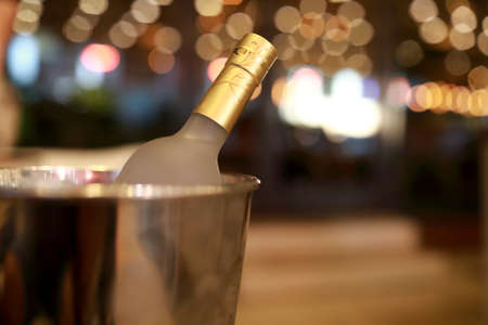 Bottle of vodka in ice bucket in restaurant at nightの写真素材
