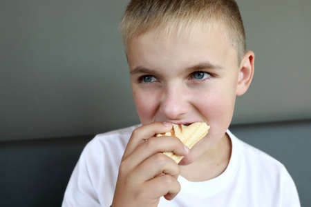 Hungry child has Hot Dog in restaurant
