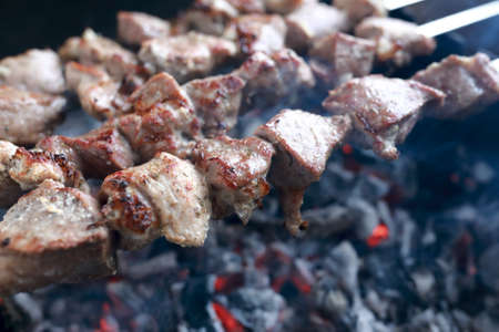 Cooking of pork neck kebab on skewersの写真素材