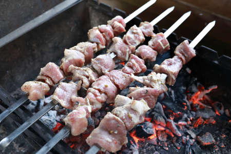 Cooking of pork neck shashlik on skewersの写真素材
