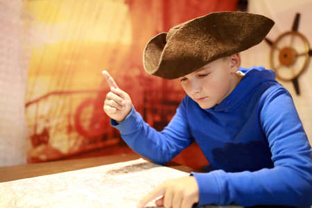 Portrait of boy in cocked hat with map