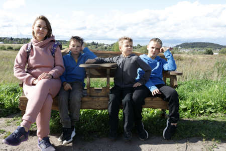 Mother with sons resting on bench, Kareliaの写真素材