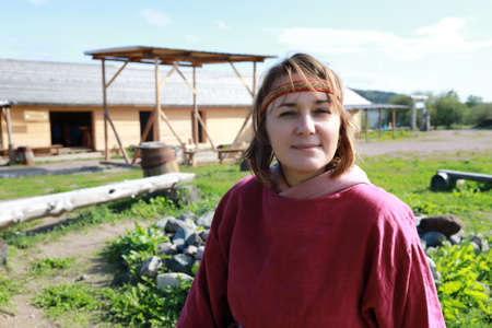 Woman in Scandinavian folk clothes in village, Kareliaの写真素材