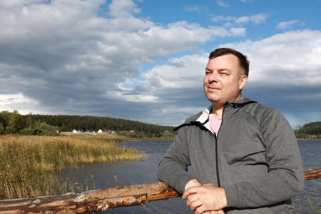 Man on bridge against background of Lake Ladoga, Kareliaの写真素材