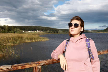 Woman on bridge against background of Lake Ladoga, Kareliaの写真素材