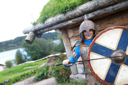 Portrait of child posing in Viking Armor with shield, Kareliaの写真素材