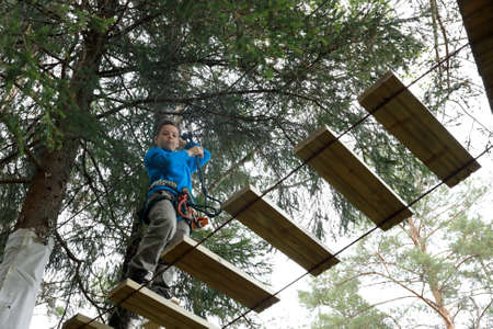 Child on obstacle course in rope park, Kareliaの写真素材