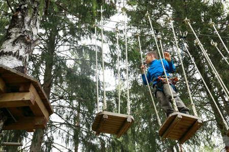 Child passing obstacle course in rope park, Kareliaの写真素材