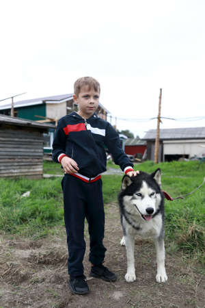 Kid with husky dog in summer, Kareliaの写真素材