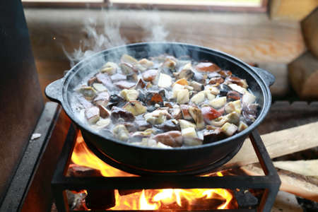 Boiling boletus in cauldron on fire in gazebo, Kareliaの写真素材
