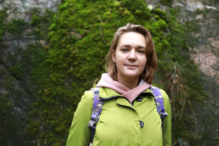 Woman on background of moss wall, Karelia