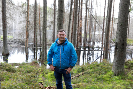 Man on background of flooded lake, Karelia