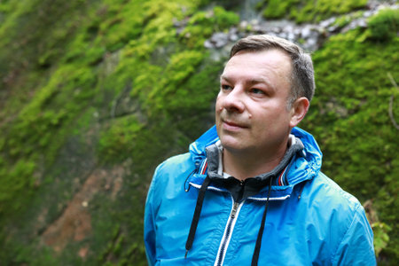 Man on background of moss wall, Karelia