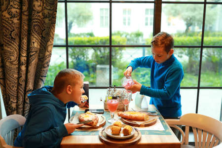 Portrait of boys have lunch in restaurant