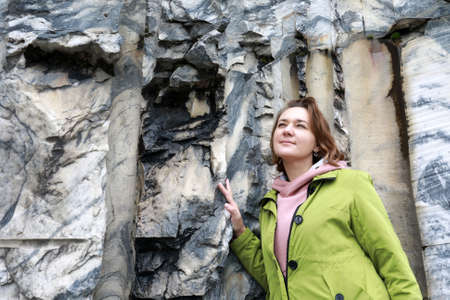 Portrait of woman on marble wall background in italian quarry, Ruskeala, Kareliaの写真素材