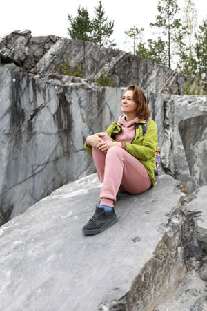Woman posing on marble slab in italian quarry, Ruskeala, Kareliaの写真素材