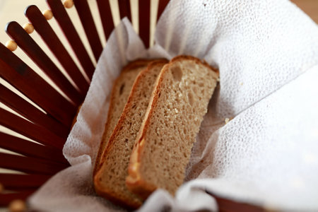 Three pieces of bread in basket in restaurantの写真素材