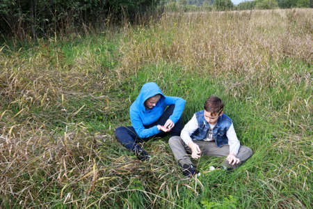 Two children resting on grass in summer, Kareliaの写真素材