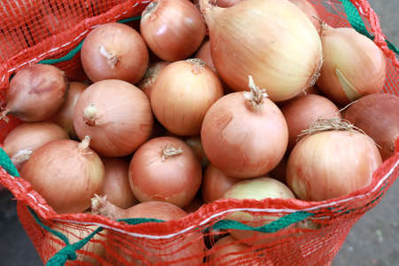 View of onions in bag on marketの写真素材