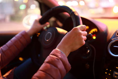 Person driving a car in the eveningの写真素材