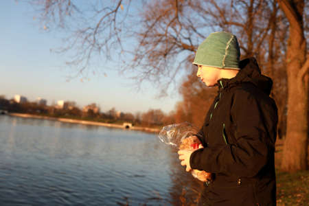 Portrait of child by lake at sunsetの写真素材