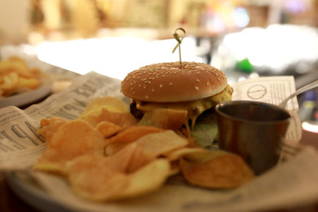 Burger with nachos on bar at nightの写真素材