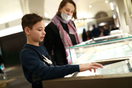 Mother with son using touch screen in Entertainment Centerの写真素材