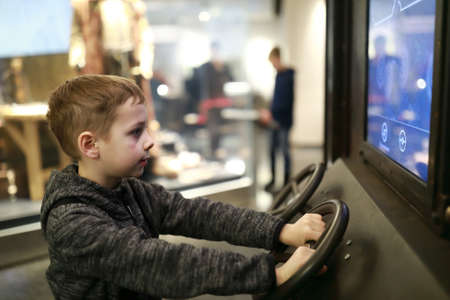 portrait of boy playing racing simulator game