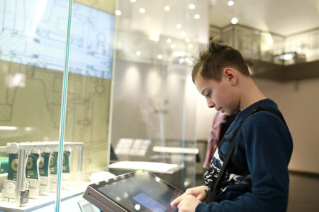 Portrait of child playing with touch screen in Entertainment Centerの写真素材