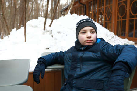 Portrait of child relaxing in winter cafeの写真素材