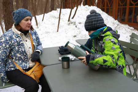 Portrait of mother with son in winter cafeの写真素材