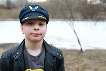 Portrait of child in flight cap in parkの写真素材