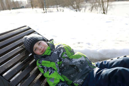 Kid resting on wooden sunbed in springの写真素材