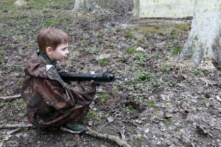 Portrait of boy playing laser tag in parkの写真素材