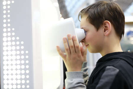 Portrait of boy watching movie with virtual binocularsの写真素材