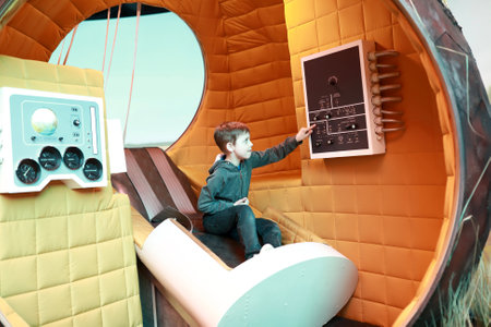 Moscow, Russia. May 2, 2022. Editorial Use Only. Child sitting in space descent vehicle at VDNKh.
