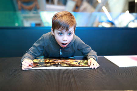 Portrait of surprised child in art gallery