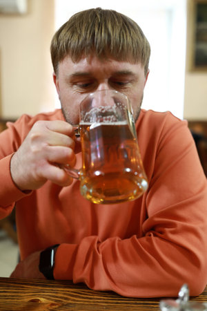 Man drinking light beer in a pub