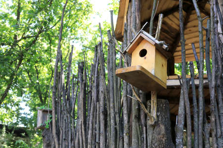 View of nesting box on fence in parkの写真素材