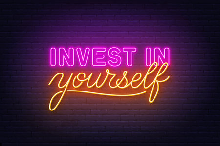 Invest in yourself neon lettering on brick wall background.のイラスト素材