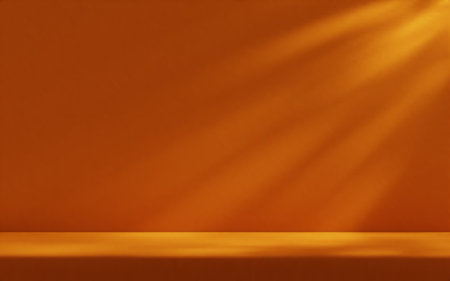 Orange studio room wall, illuminated by sunlight through foliage with tabletop. Product presentation...